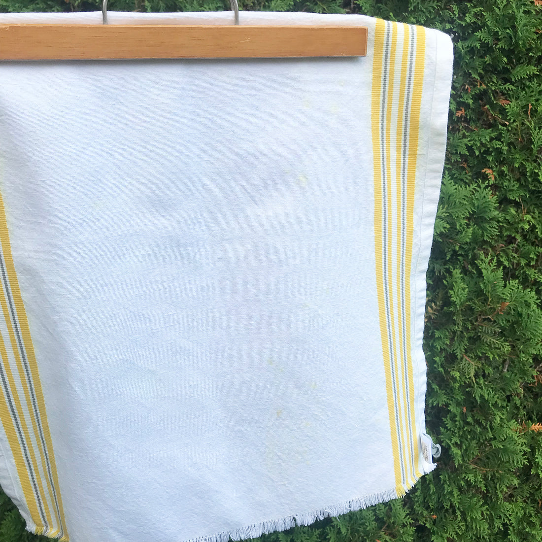 White bar towel with yellow order stripes. 